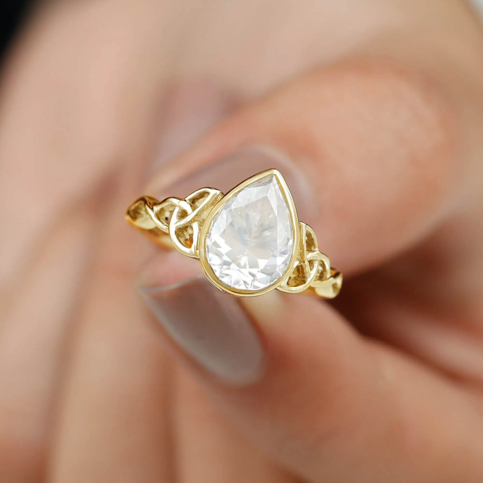 Pear Shape Moissanite Solitaire Celtic Knot Ring in Bezel Setting